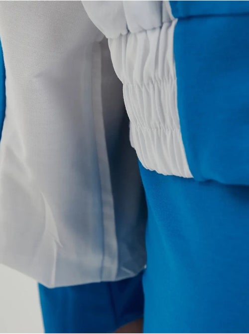 Blusa de fato de treino com botões e gola alta em blocos de cor - Kiabi Blusa de fato de treino com botões e gola alta em blocos de cor - Kiabi