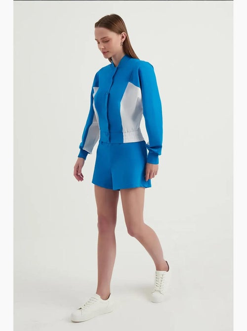 Blusa de fato de treino com botões e gola alta em blocos de cor hiccup - Kiabi Blusa de fato de treino com botões e gola alta em blocos de cor hiccup - Kiabi