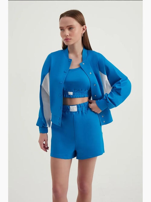 Blusa de fato de treino com botões e gola alta em blocos de cor hiccup - Kiabi Blusa de fato de treino com botões e gola alta em blocos de cor hiccup - Kiabi