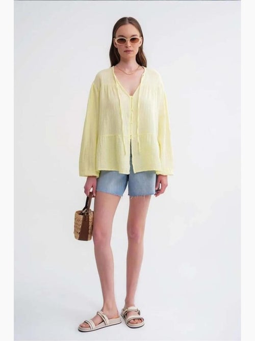 Blusa de manga comprida de corte descontraído com laço no decote mixray - Kiabi Blusa de manga comprida de corte descontraído com laço no decote mixray - Kiabi