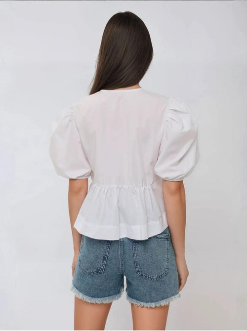 Blusa em algodão com gola redonda e detalhe de laço hiccup - Kiabi Blusa em algodão com gola redonda e detalhe de laço hiccup - Kiabi
