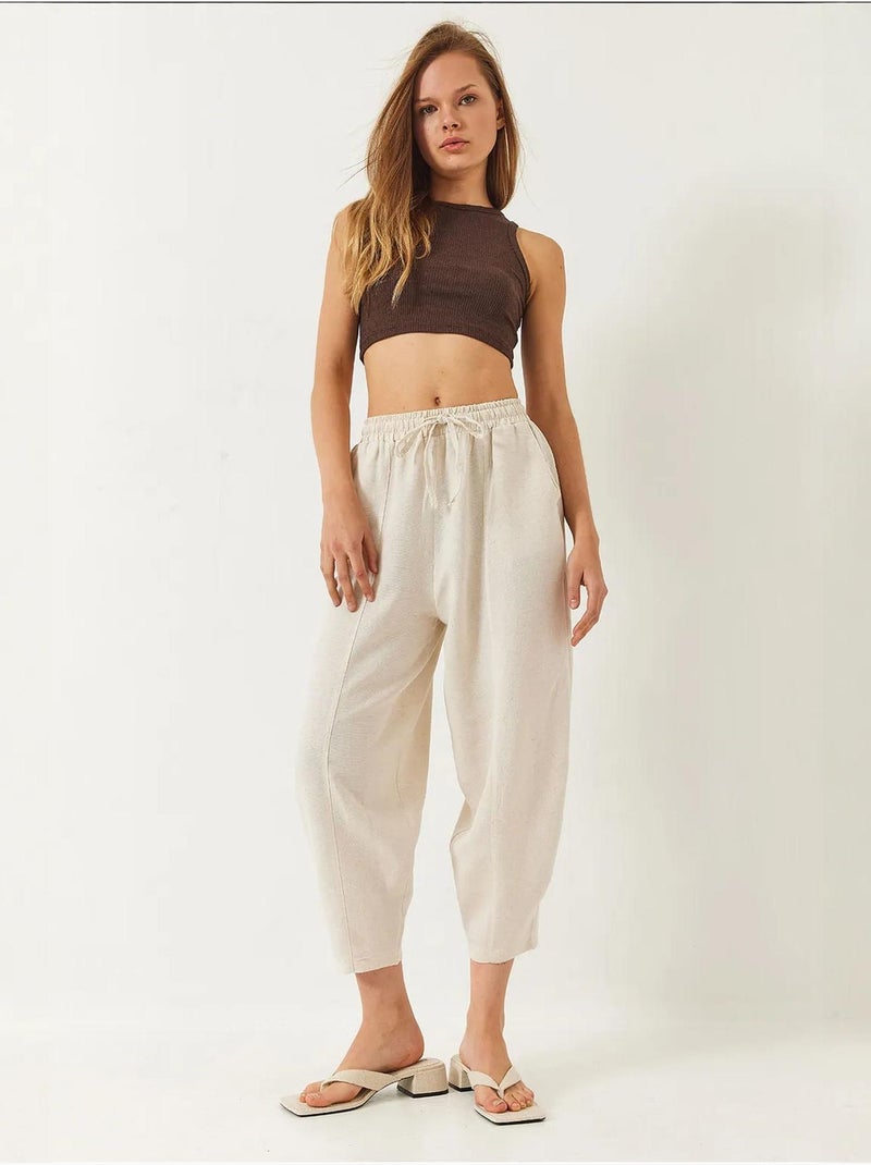 Calça com cintura elástica e virilha descaída com detalhe de bolso lucci Bege-argila - Kiabi