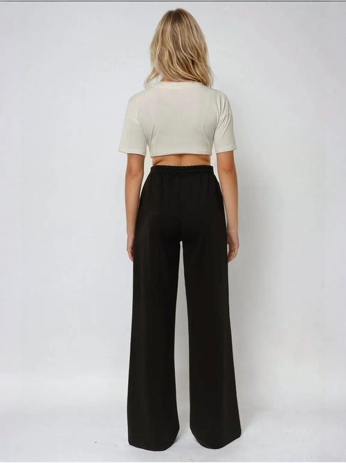 Calça de fato de treino elástica de perna larga hiccup - Kiabi Calça de fato de treino elástica de perna larga hiccup - Kiabi
