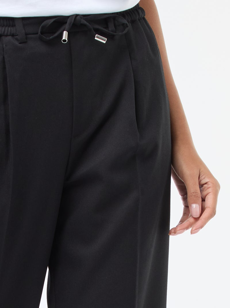 Calças de corte largo com cintura elástica + cordões para atar Preto - Kiabi