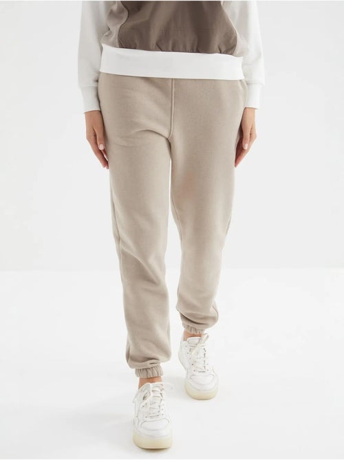 Calças de fato de treino jogger em fleece de cintura subida para mulher tommy - Kiabi Calças de fato de treino jogger em fleece de cintura subida para mulher tommy - Kiabi