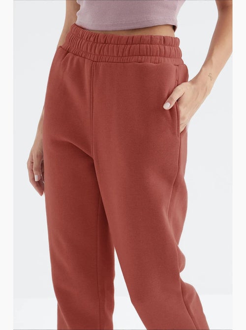 Calças de fato de treino jogger em fleece de cintura subida para mulher tommy - Kiabi Calças de fato de treino jogger em fleece de cintura subida para mulher tommy - Kiabi