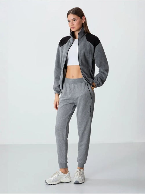 Calças de fato de treino jogger em mistura de algodão para mulher tommy - Kiabi Calças de fato de treino jogger em mistura de algodão para mulher tommy - Kiabi