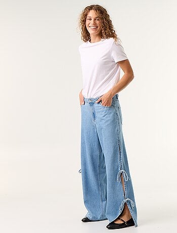 Calças de ganga wide leg largas com laços fantasia na bainha