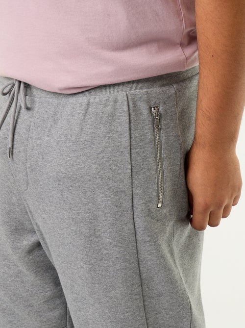 Calças de jogging com punho elástico e bolsos com fecho - Kiabi Calças de jogging com punho elástico e bolsos com fecho - Kiabi