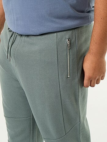 Calças de jogging com punho elástico e bolsos com fecho