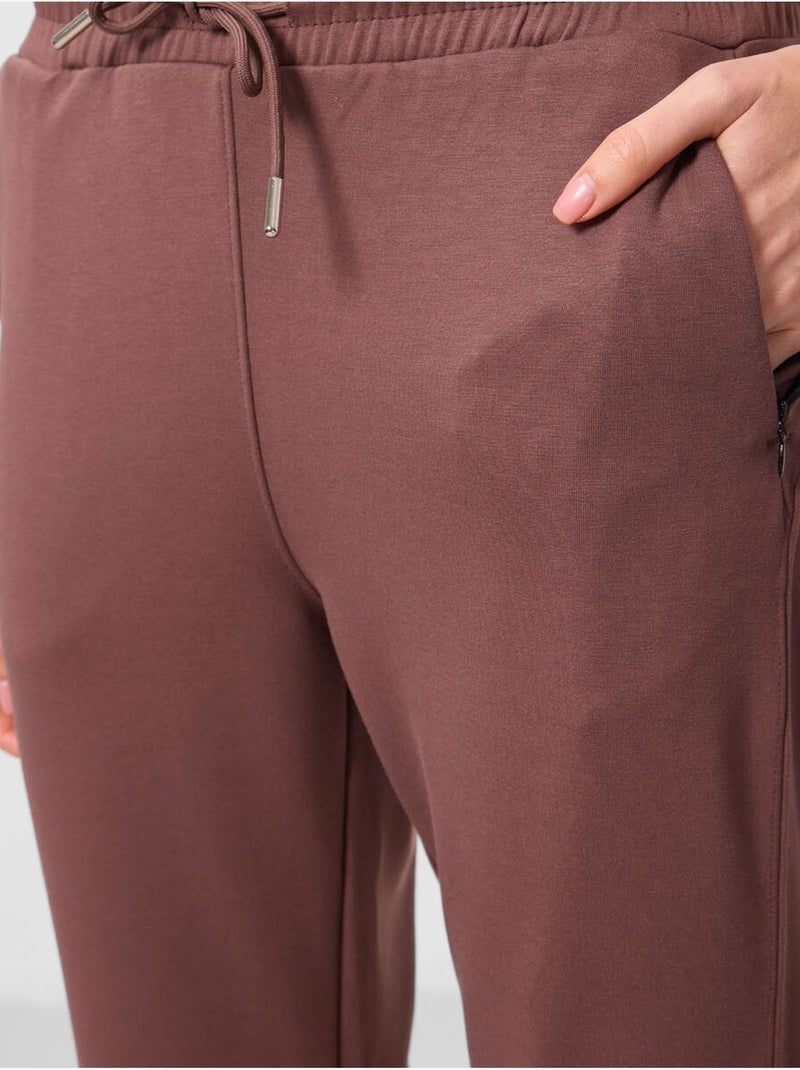Calças jogger de mulher com fecho de correr tommy Castanho - Kiabi