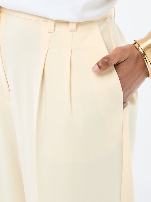 Calças largas de cintura subida com 5 bolsos - Kiabi