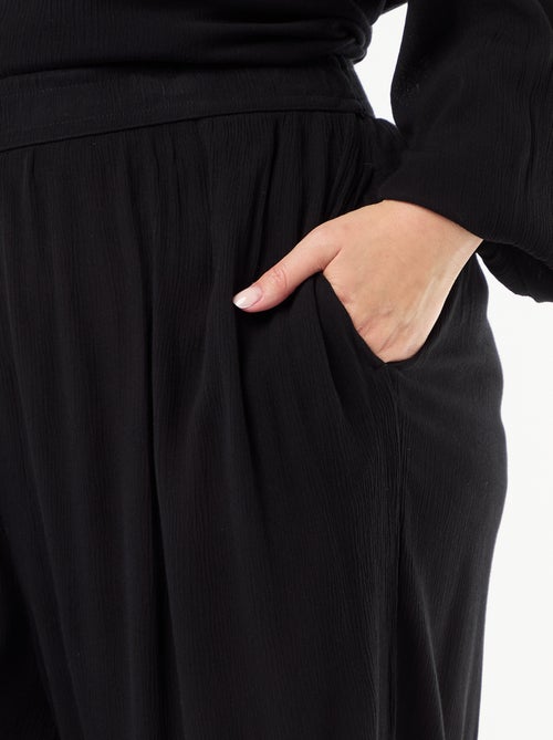 Calças largas em malha crepe - Kiabi