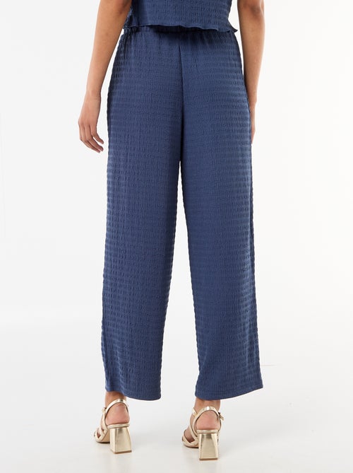 Calças largas em malha smock - Kiabi