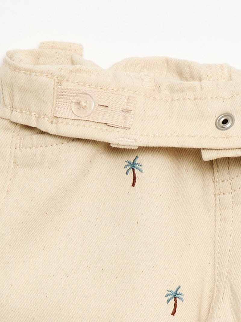 Calças paperbag bordadas all-over em sarja de algodão Bege - Kiabi