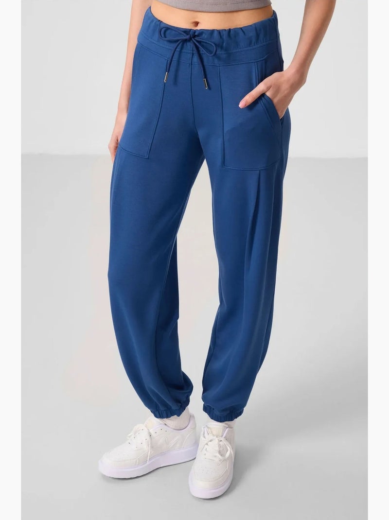Calças relaxed de crepe de cintura média com bolso tommy Azul - Kiabi