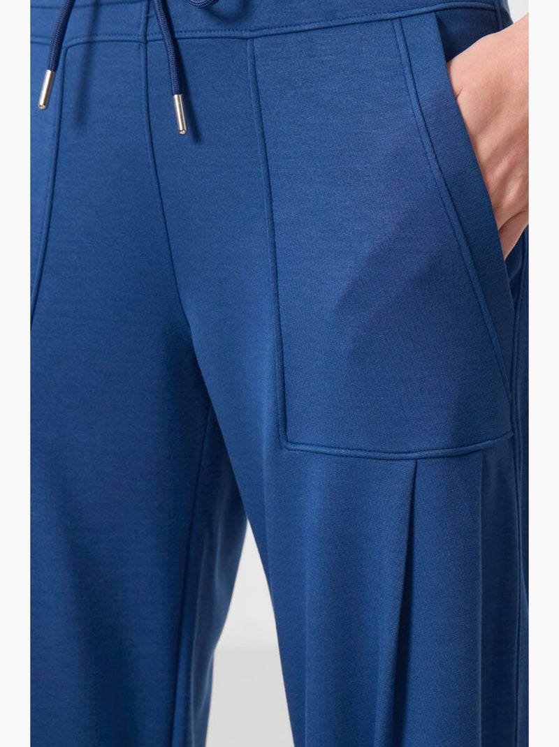 Calças relaxed de crepe de cintura média com bolso tommy Azul - Kiabi