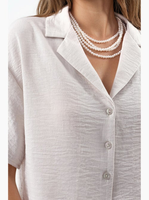 Camisa curta texturada com fecho de botões busem - Kiabi Camisa curta texturada com fecho de botões busem - Kiabi