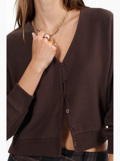 Cardigan curto canelado com decote em v busem - Kiabi Cardigan curto canelado com decote em v busem - Kiabi