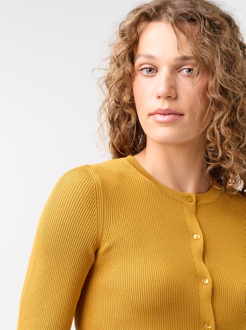 Cardigan liso canelado com acabamentos em folhos - Kiabi Cardigan liso canelado com acabamentos em folhos - Kiabi