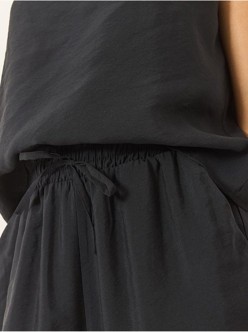 Conjunto coordenado com camisola sem mangas e calças de perna larga lucci - Kiabi Conjunto coordenado com camisola sem mangas e calças de perna larga lucci - Kiabi
