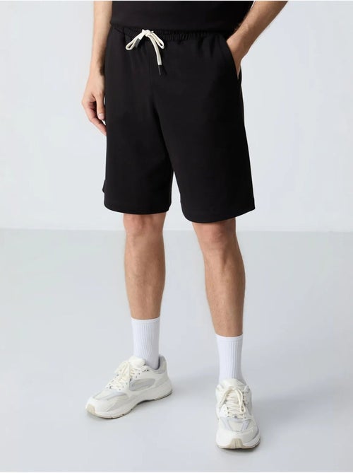 Conjunto de homem de t-shirt oversized e calções em mistura de algodão tommy - Kiabi Conjunto de homem de t-shirt oversized e calções em mistura de algodão tommy - Kiabi
