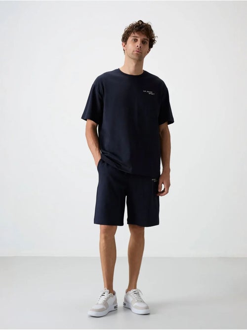 Conjunto de t-shirt oversized de manga curta e calções tommy - Kiabi Conjunto de t-shirt oversized de manga curta e calções tommy - Kiabi