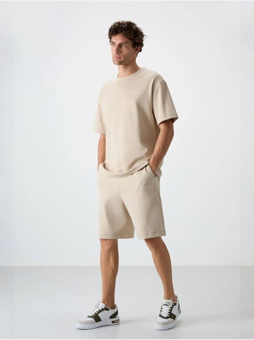 Conjunto de t-shirt oversized de manga curta e calções tommy - Kiabi Conjunto de t-shirt oversized de manga curta e calções tommy - Kiabi