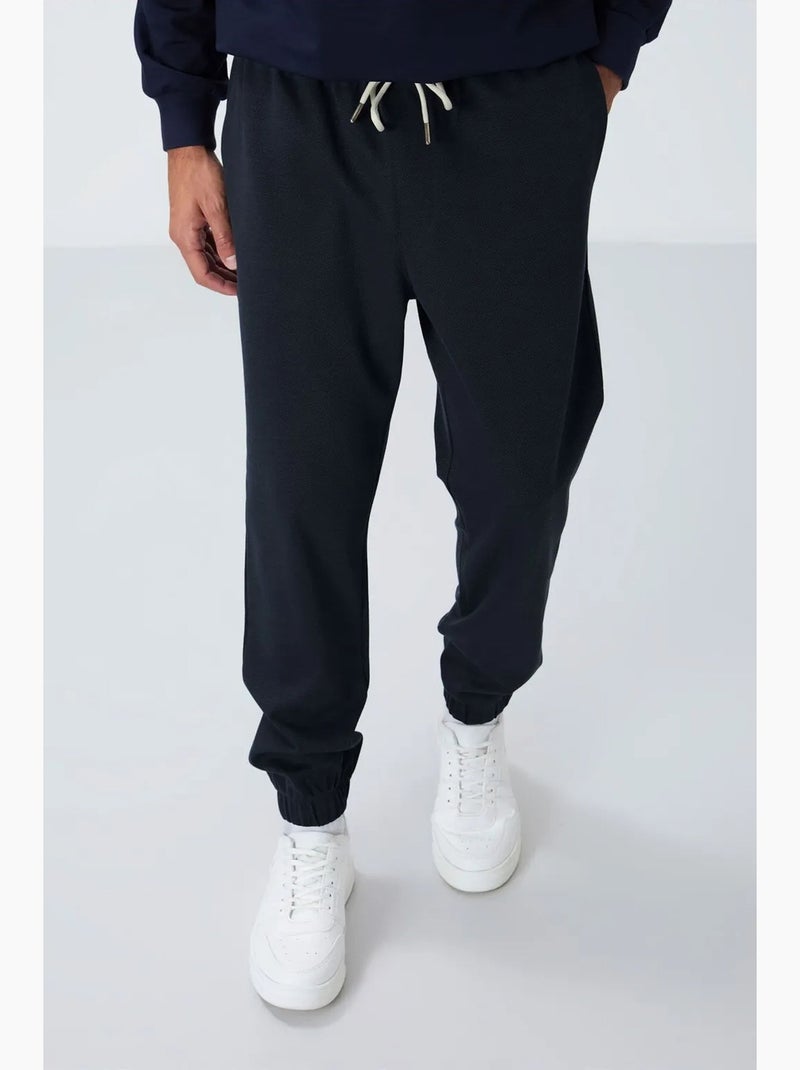 Men's calças de fato de treino em polar de corte regular tommy Índigo - Kiabi