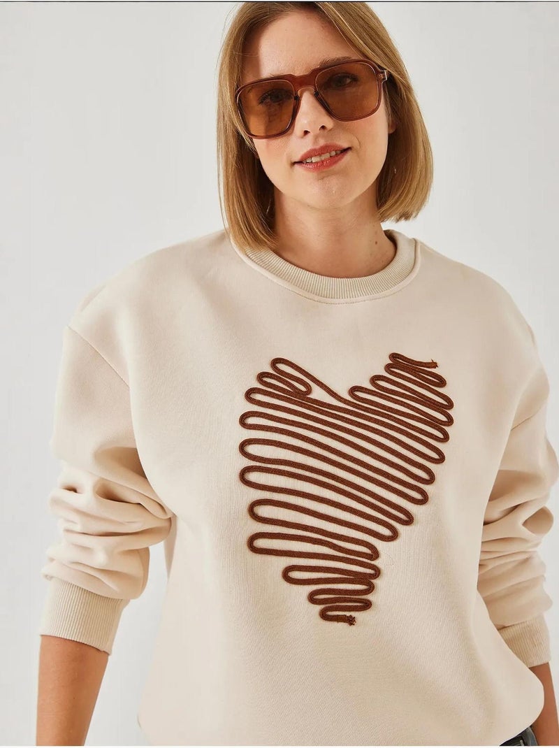 Sweatshirt bordada com coração lucci Creme - Kiabi